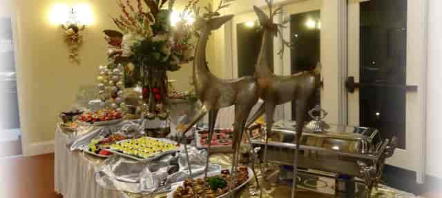 Elegant buffet at Sorelle Italian Bistro with gourmet dishes and stylish deer sculptures.