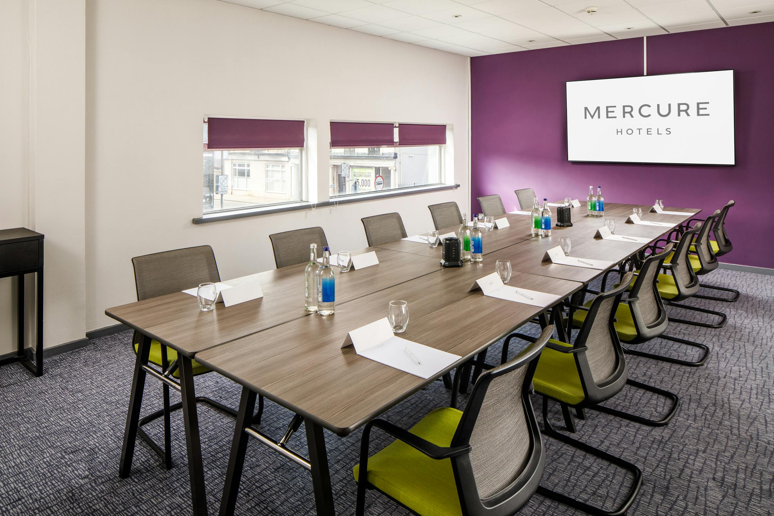 Modern meeting room at Mercure Bedford Hotel with ergonomic chairs for corporate events.