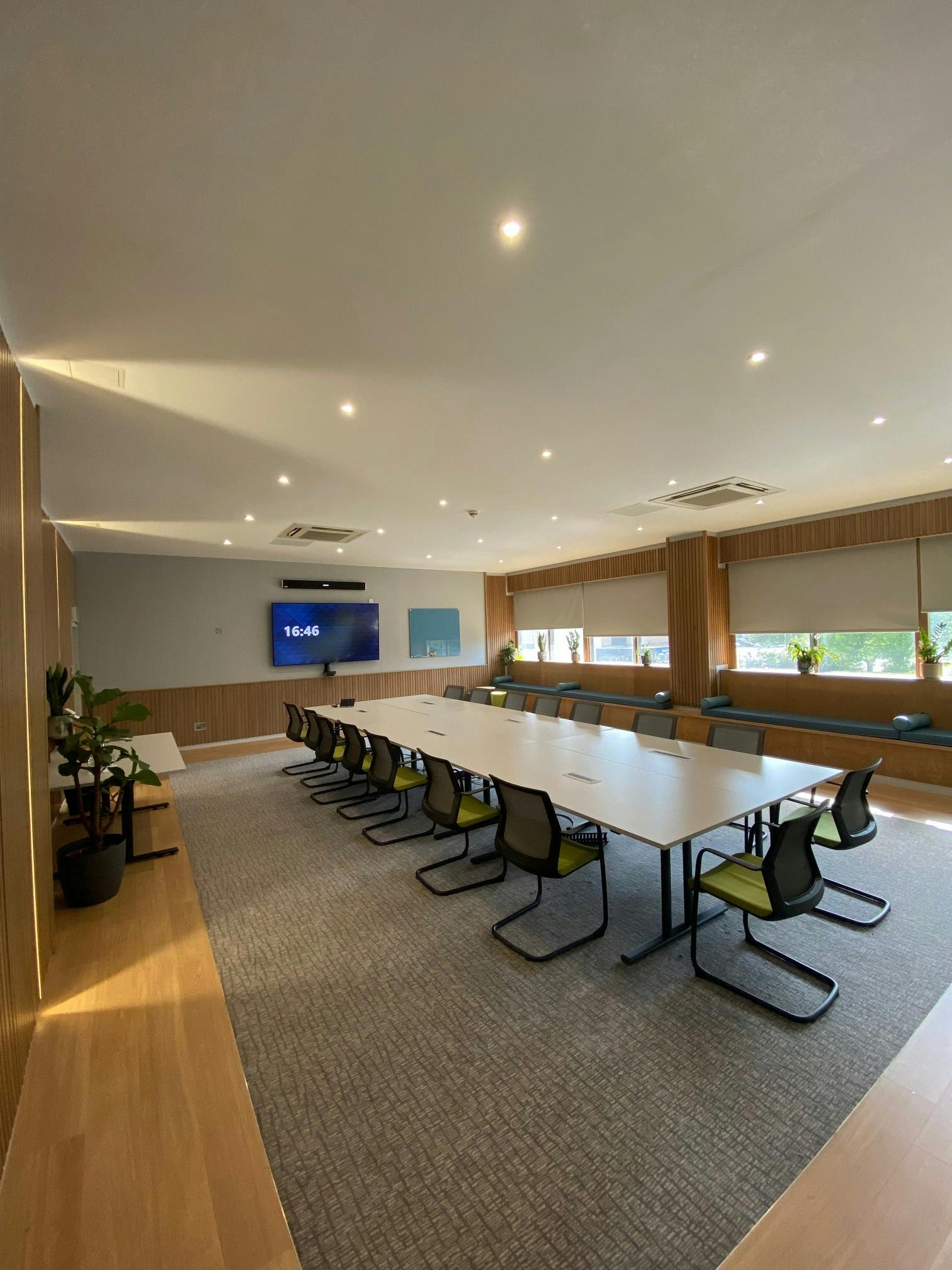 Modern meeting room at Mercure Bedford Hotel with large windows for collaboration.