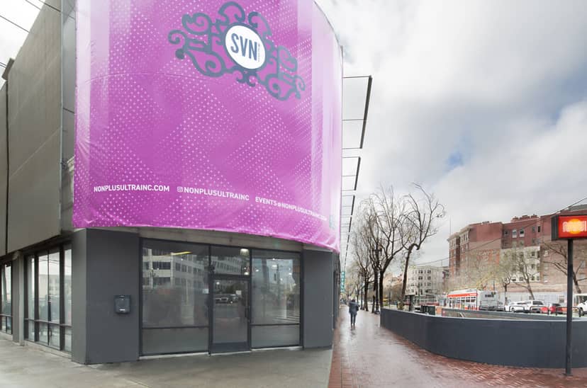 Large rooftop venue with vibrant purple facade, perfect for corporate events and gatherings.