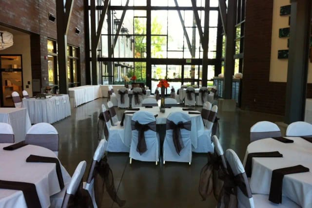 Grand Hall at Green River Center, spacious venue with elegant tables for events and gatherings.
