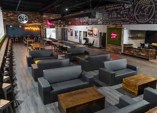 Paddock Lounge at K1 Speed: modern event space with cozy seating for gatherings and meetings.