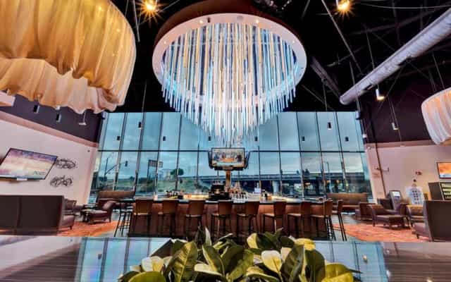 Modern event space at Casino M8trix with elegant chandelier for corporate meetings and celebrations.