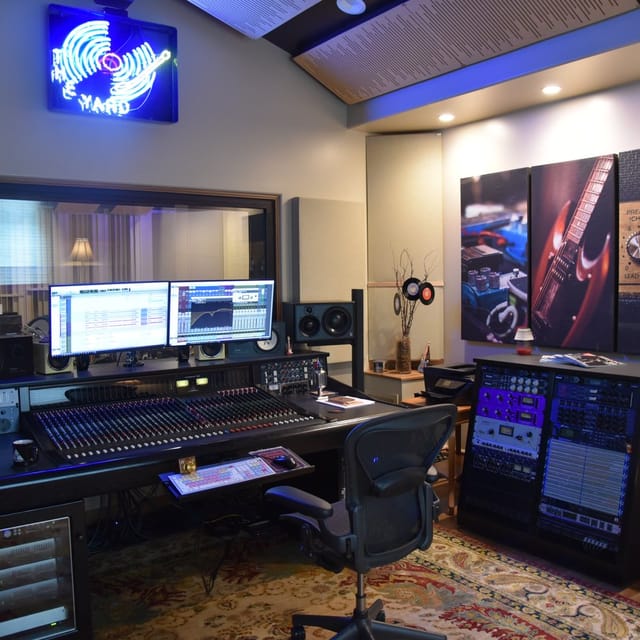 Modern audio recording studio with dual monitors, ideal for music production workshops.