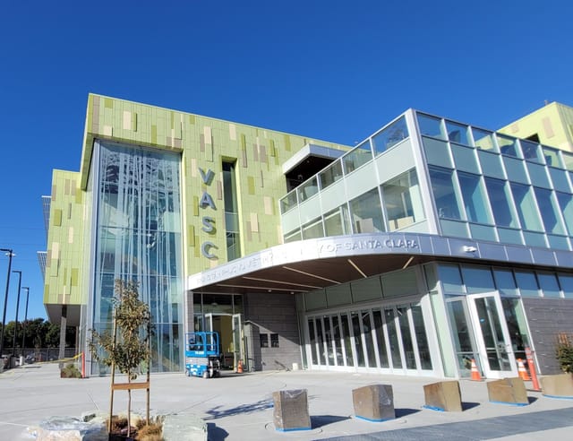 Modern La Salle Community Center with green facade, ideal for events and meetings.