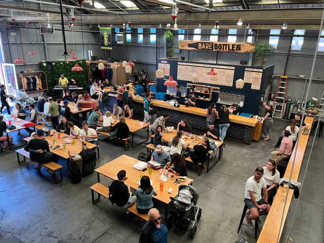 Lounge at Barebottle Brewing Co. with communal tables for casual gatherings and events.