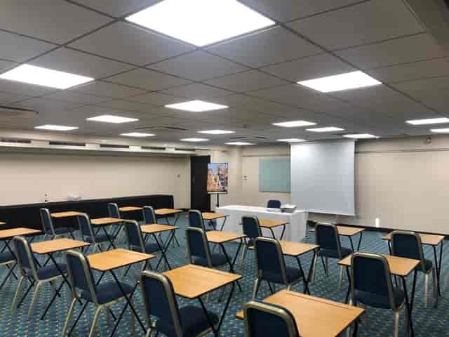 Meeting room setup for presentation at Mercure Cardiff North Hotel, featuring folding chairs.
