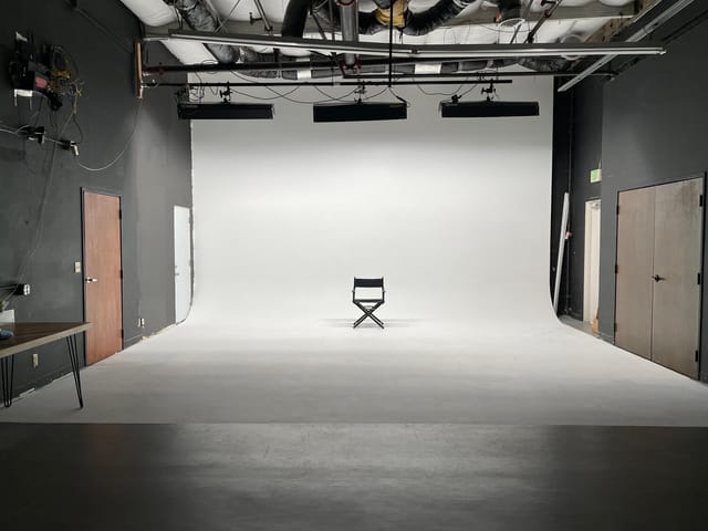 Minimalist studio space with clean backdrop for meetings and presentations.