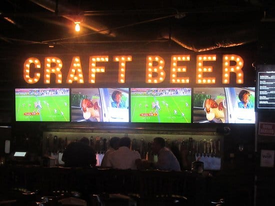 Vibrant Parktown Pizza Company bar with "CRAFT BEER" sign, ideal for watch parties.