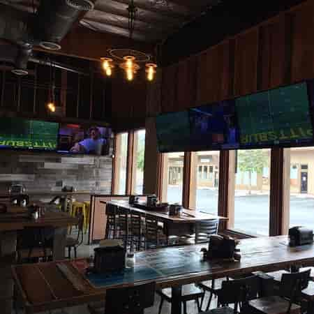 Modern event space at Parktown Pizza Company with large screens for networking events.
