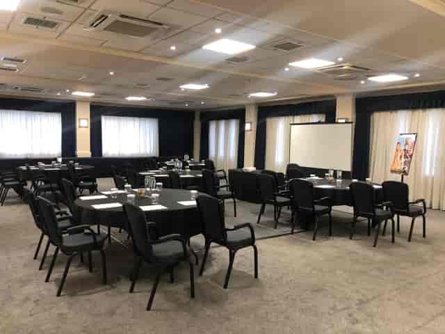 Carmarthen Suite meeting room with round tables, ideal for corporate events and workshops.