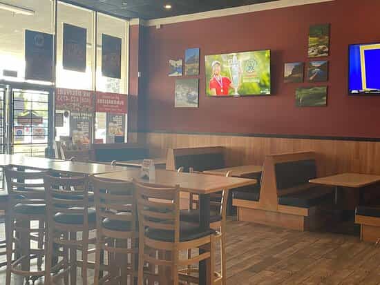 Casual dining area at Mountain Mike's Pizza with booths, ideal for events and meetings.