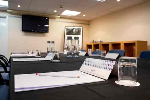 Meeting room setup at Mercure Cardiff North Hotel with organized table and presentation screen.
