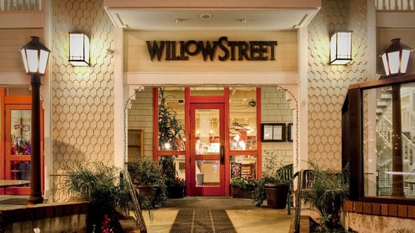 Charming entrance with red doors at Willow Street Wood-Fired Pizza for events.