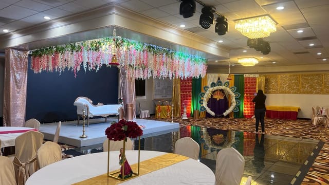 Elegant event space with floral drapes, ideal for weddings and formal gatherings.