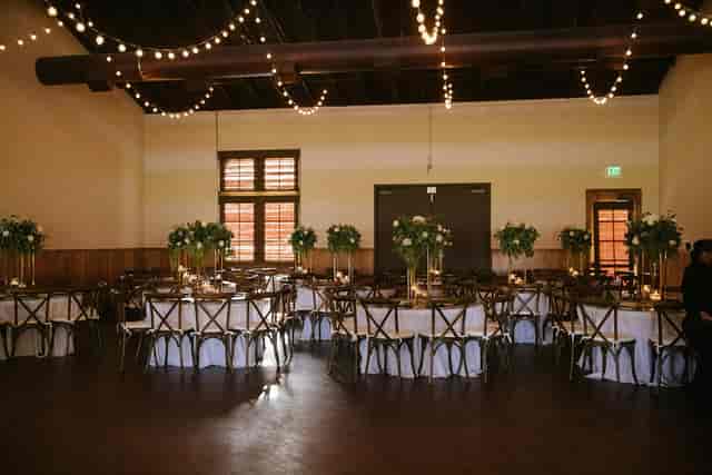 Elegant event space with floral centerpieces, perfect for weddings and gatherings.