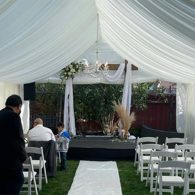 Outdoor wedding venue with elegant drapery and floral arrangements for intimate gatherings.