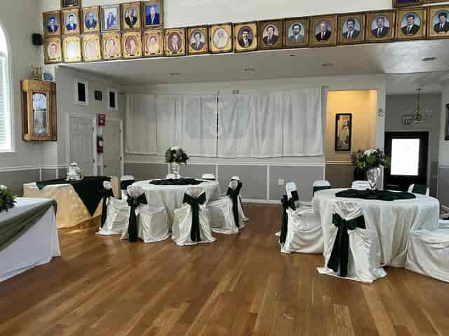 Elegant event space with dark green and white decor, perfect for weddings and gatherings.