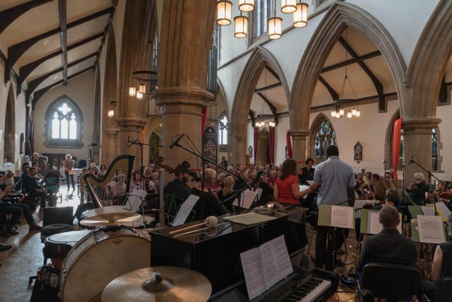 St Matthias Church concert venue with stained glass windows and orchestra setup.