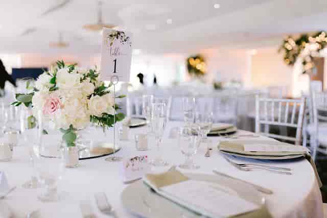 Elegant wedding banquet table with floral centerpiece at San Jose Country Club.