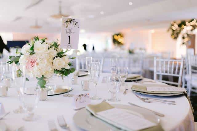 Elegant wedding banquet table with floral centerpiece at San Jose Country Club.