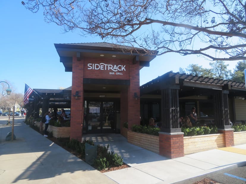 Vibrant outdoor seating at Sidetrack Bar & Grill for casual meetings and events.