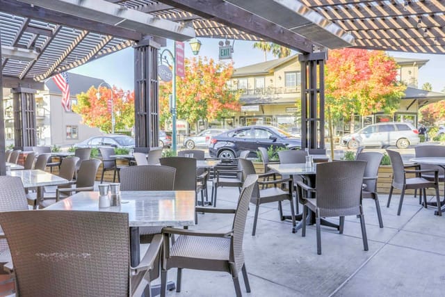Outdoor dining area at SideTrack Bar + Grill, perfect for casual meetings and networking.