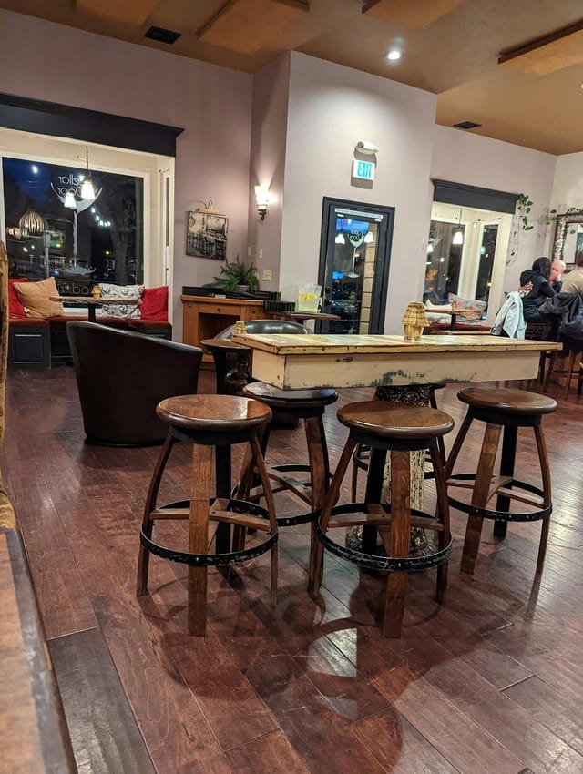 Cozy patio in Cellar Door with rustic table, ideal for small events and meetings.