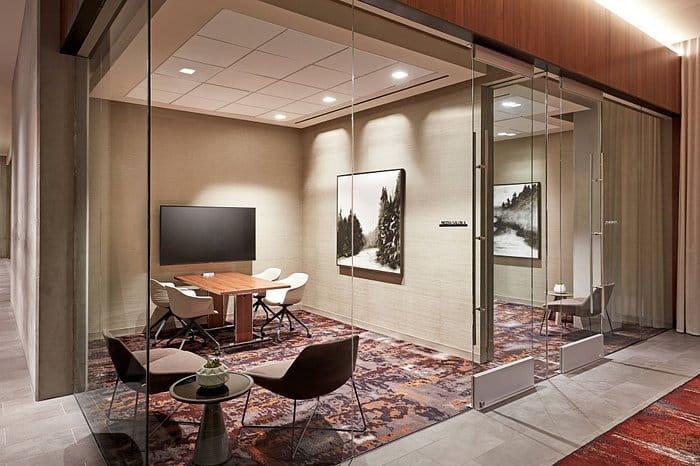 Modern meeting room with glass enclosure at AC Lounge, perfect for team meetings and presentations.