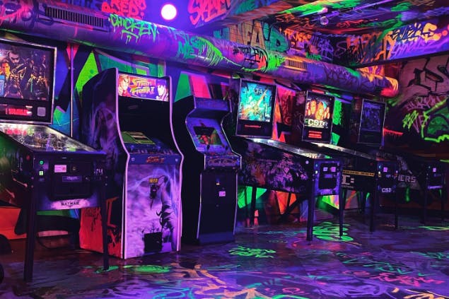 "Vibrant graffiti arcade at Newcastle Activity Bar for casual gatherings and team-building events."