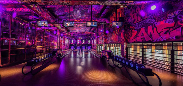 Vibrant graffiti bowling alley at Durham Activity Bar for corporate events and team-building.