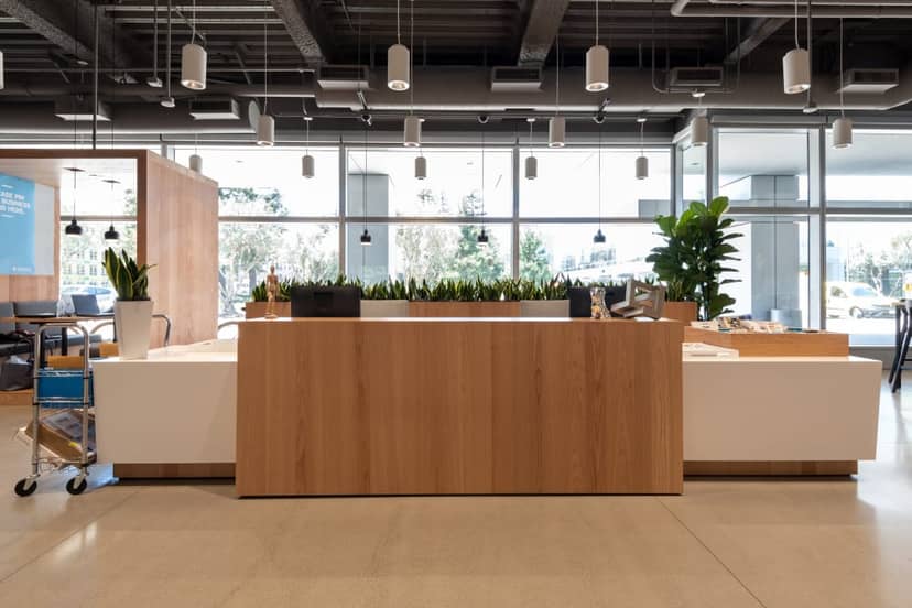 Modern reception area with wooden desk, ideal for meetings and events in Santa Clara.