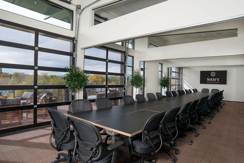 Modern conference room with sleek table, ideal for corporate meetings and events.