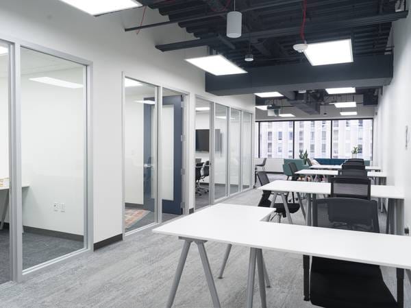 Modern meeting space with glass-walled rooms, ideal for workshops and team gatherings.
