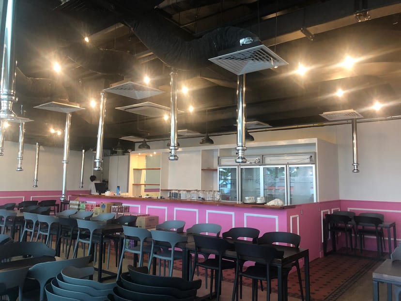 Modern event space at Siam Square Mookata with sleek design, ideal for gatherings and dining.