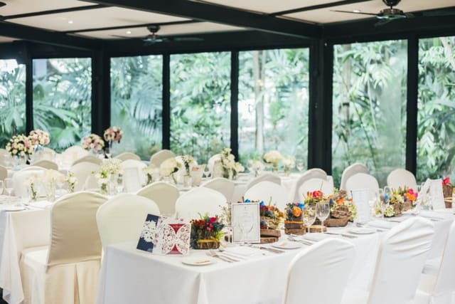 Elegant wedding venue at The Villa, Singapore Botanic Gardens with floral centerpieces.