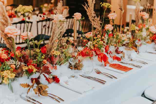 Elegant event table with floral centerpiece, perfect for weddings and upscale gatherings.