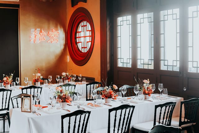 Elegant dining setup with floral centerpieces for corporate dinners and private celebrations.