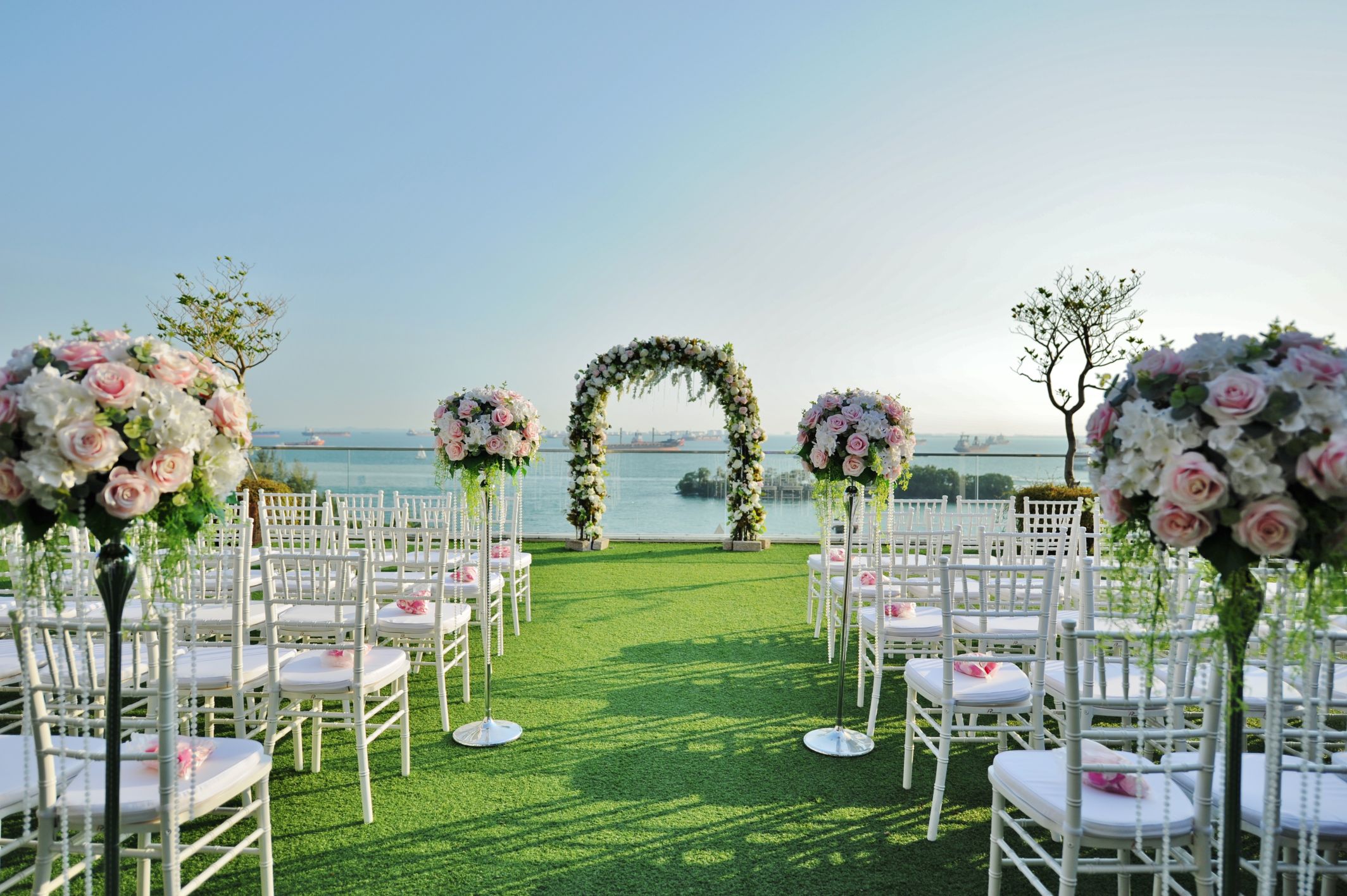 Outdoor wedding venue at Sky Garden Sentosa with floral arch and lush greenery.