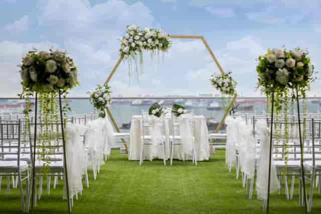Outdoor wedding ceremony at Sky Garden Sentosa with floral hexagonal arch and scenic view.