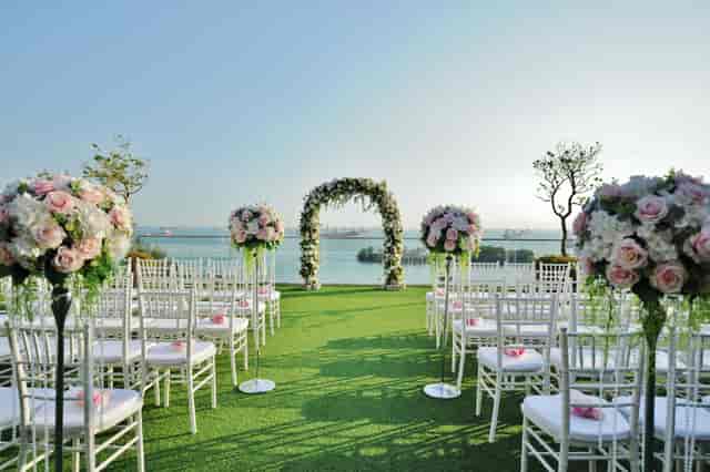 Outdoor wedding venue at Sky Garden Sentosa with floral arch and elegant seating.