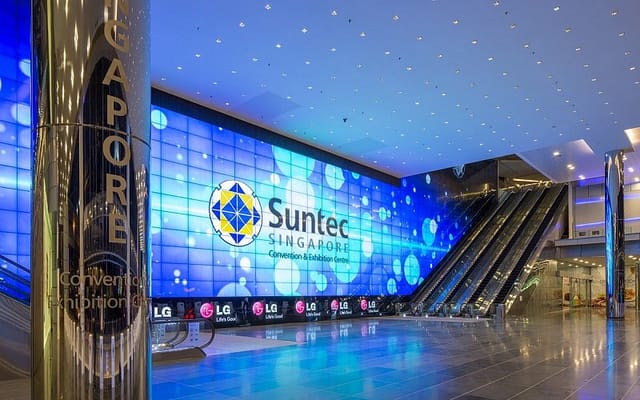 Modern event venue at Suntec Singapore with vibrant digital display for conferences.
