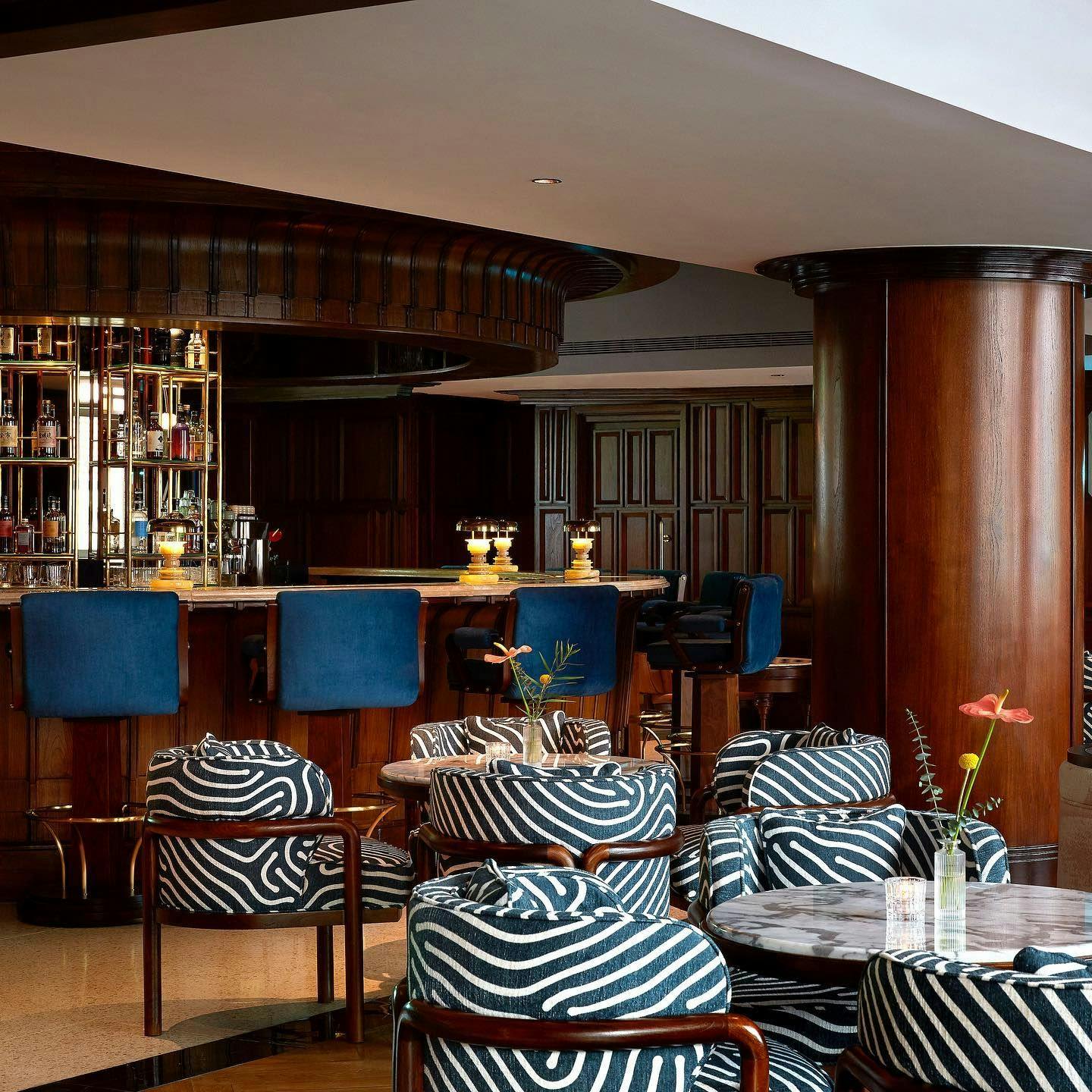 Stylish bar area with zebra-patterned chairs at Mandala Club's Pool Terrace for events.