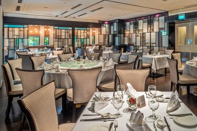 Sophisticated dining setup at The American Club Singapore for corporate events and gatherings.