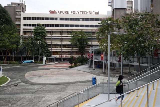 Spacious outdoor event space at Singapore Polytechnic with greenery for gatherings and workshops.