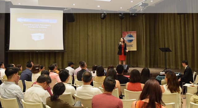 Professional speaker engaging audience in LISHA Tamil Toastmasters conference room seminar.