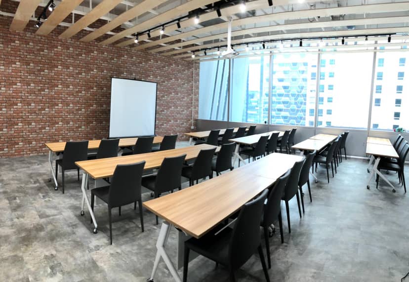 Modern classroom training room with long tables, ideal for workshops and meetings.