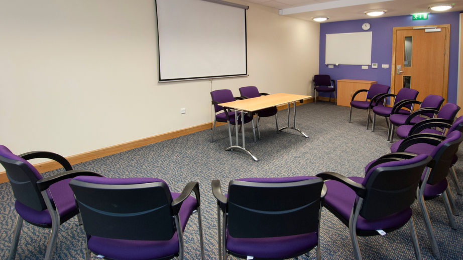 Meeting room with circular seating for workshops and presentations in Manchester City Centre. - Banner