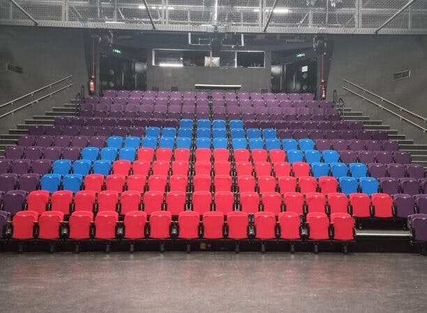 Vibrant tiered seating in Z-arts, ideal for corporate events and performances.