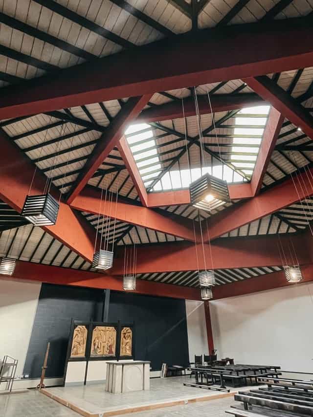 Sanctuary ceiling at Ascension Church Hulme, featuring geometric design and skylights for events.